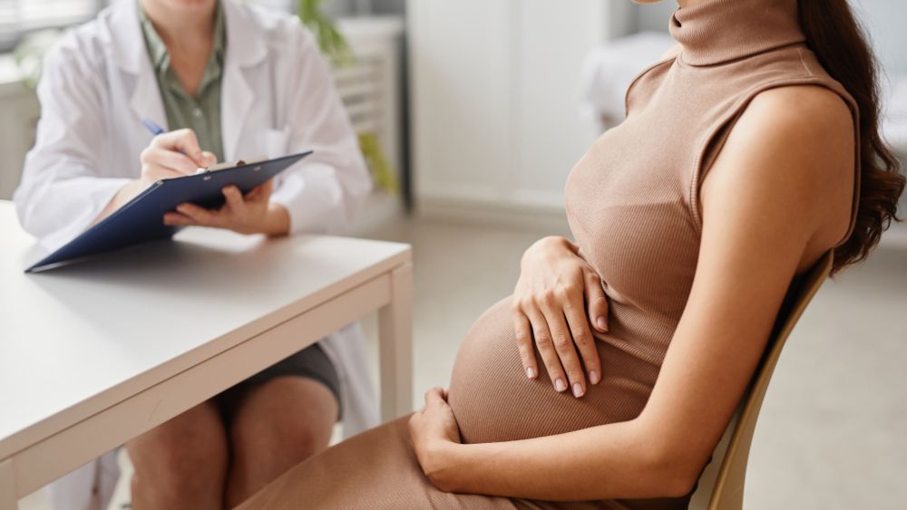 Pregnant Woman Describing Symptoms To Her Doctor - NRKSS Blog